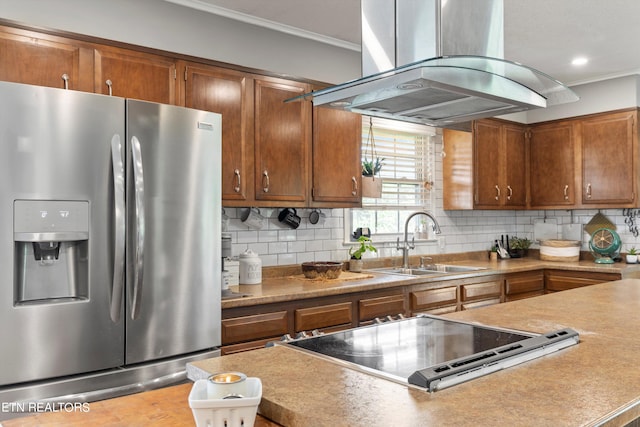 kitchen featuring sink, decorative backsplash, stainless steel fridge, and island exhaust hood