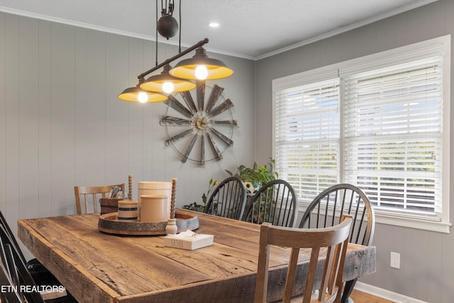 dining area featuring wood-type flooring and ornamental molding