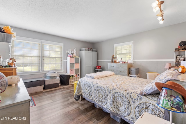 bedroom featuring hardwood / wood-style floors and a textured ceiling