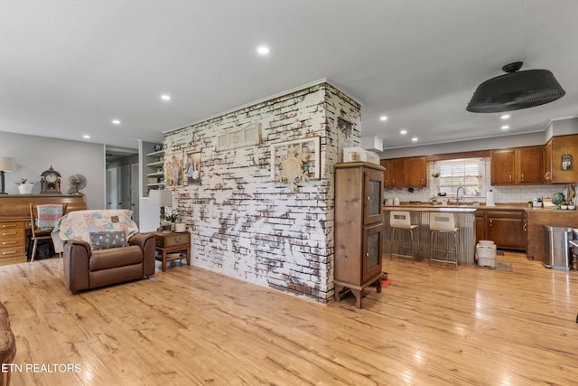 living room featuring sink and light hardwood / wood-style flooring