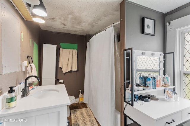 bathroom with vanity, a textured ceiling, wood-type flooring, and toilet