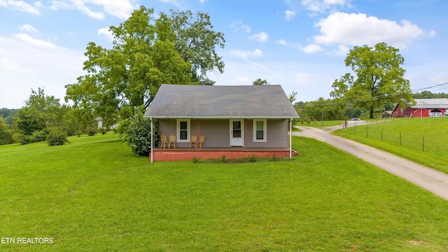 view of front of property with covered porch and a front lawn