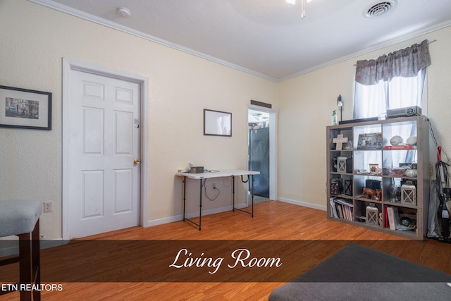 interior space with light hardwood / wood-style flooring and ornamental molding