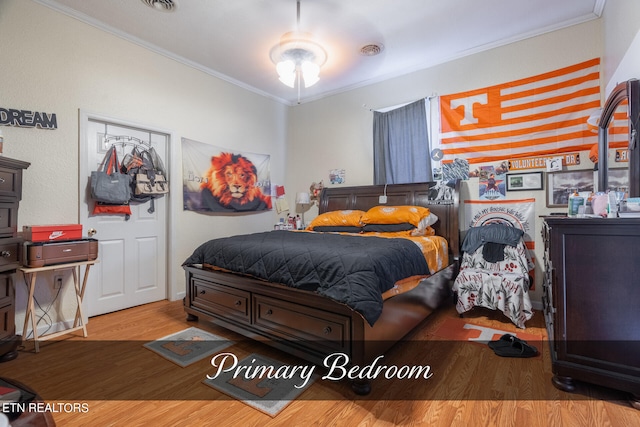 bedroom featuring hardwood / wood-style flooring and crown molding