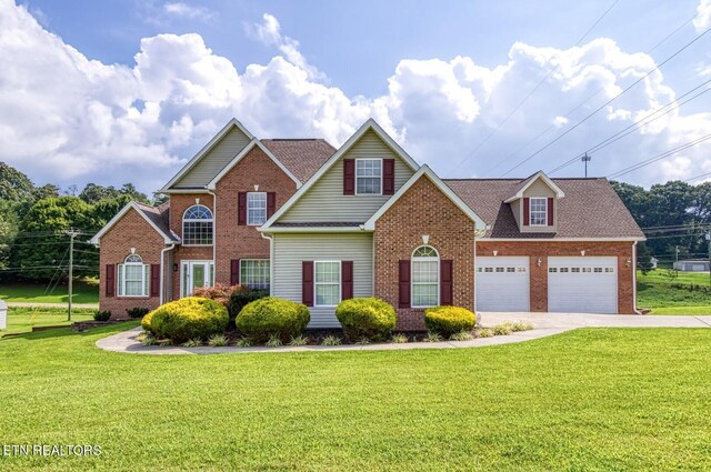 view of front property with a garage and a front yard