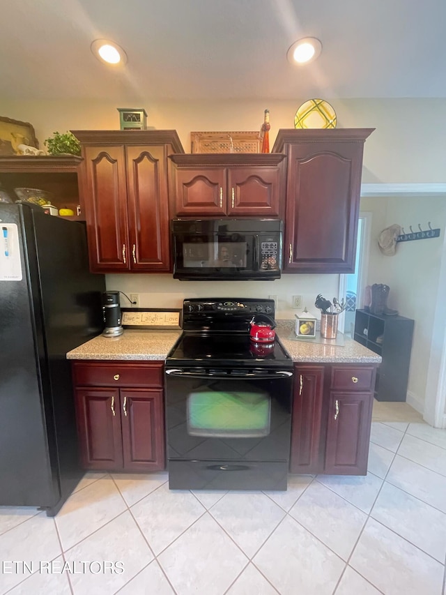 kitchen with black appliances and light tile patterned flooring