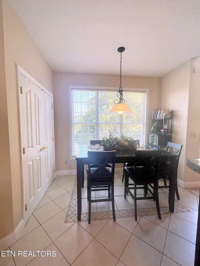 dining space featuring light tile patterned floors