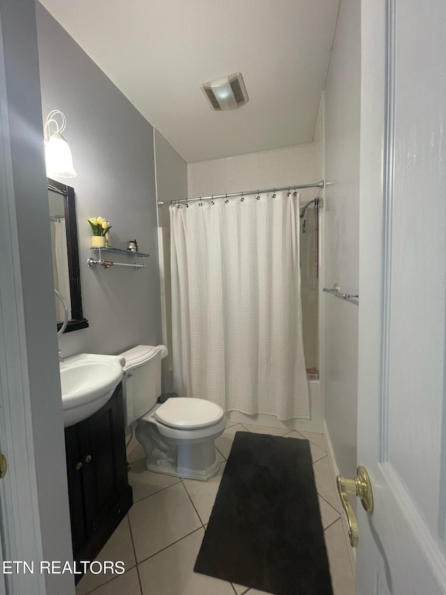 full bathroom featuring tile patterned flooring, vanity, toilet, and shower / tub combo