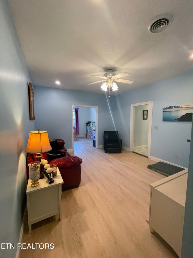 living room with hardwood / wood-style floors and ceiling fan