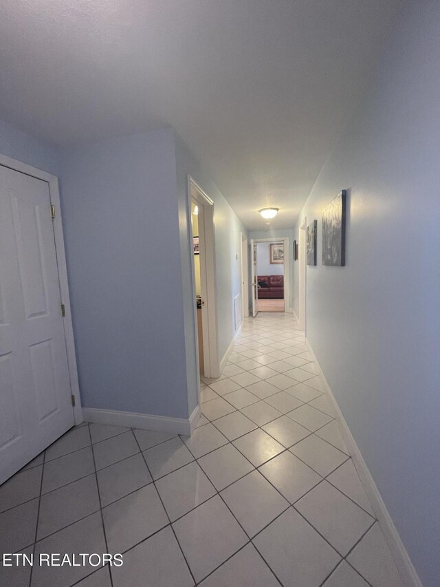 corridor with light tile patterned floors