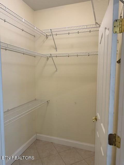 spacious closet featuring light tile patterned floors