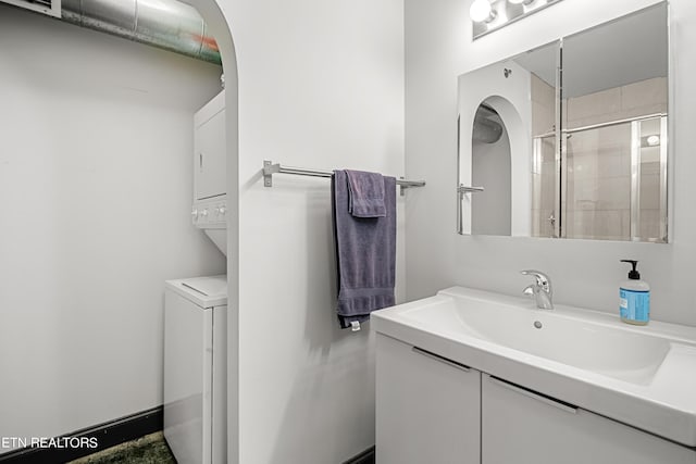 bathroom with vanity and a shower with shower door