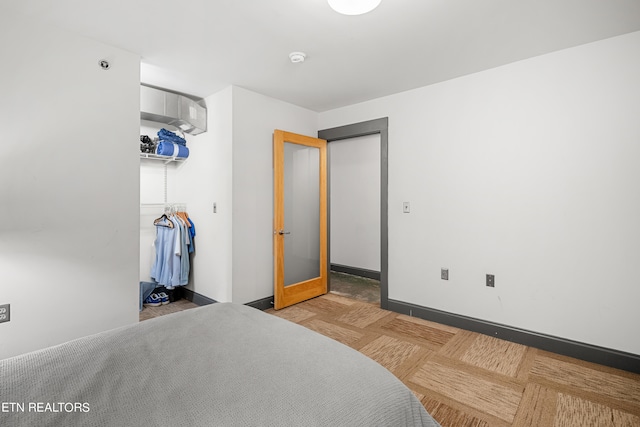 bedroom featuring light parquet flooring