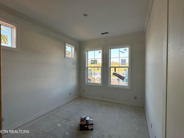 empty room featuring crown molding