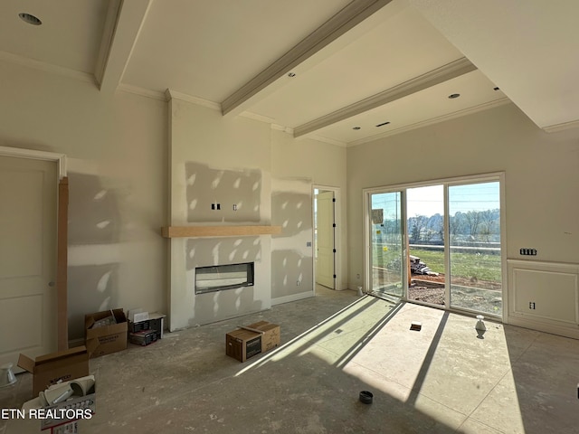 unfurnished living room with crown molding and beamed ceiling