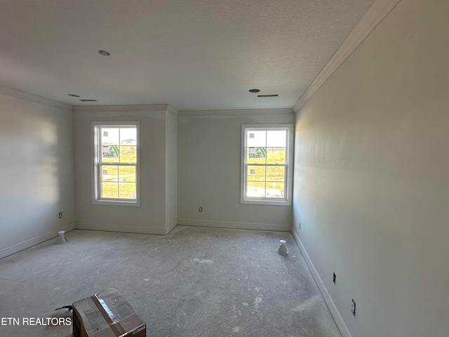 spare room with ornamental molding, a textured ceiling, and plenty of natural light