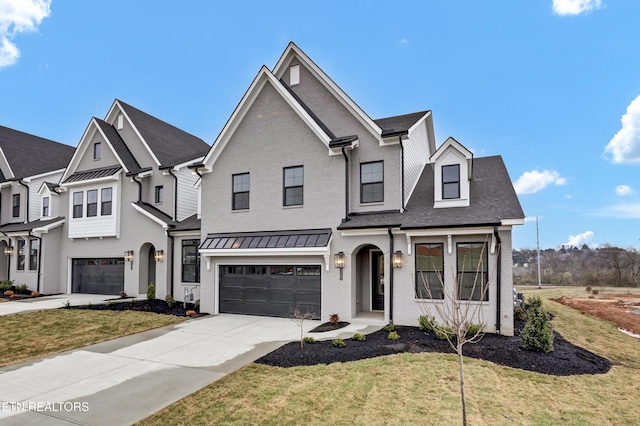 view of front of house with concrete driveway, a garage, brick siding, and a front yard