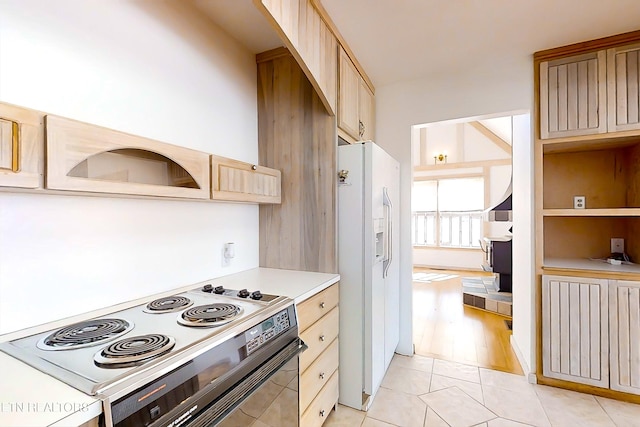 kitchen featuring white fridge with ice dispenser, light tile patterned floors, light brown cabinets, and electric range