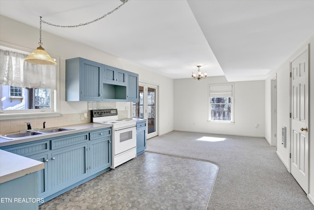 kitchen featuring decorative light fixtures, light countertops, blue cabinets, white electric range, and a sink