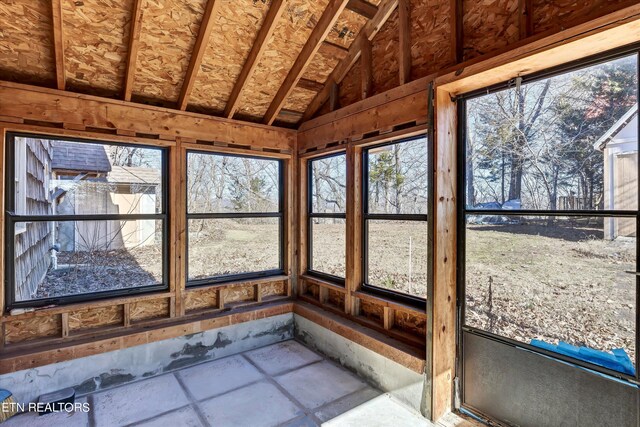 unfurnished sunroom featuring lofted ceiling