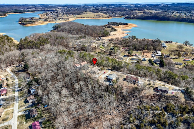 drone / aerial view featuring a water view and a wooded view