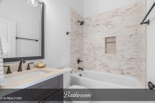 full bathroom with toilet, vanity, and tiled shower / bath