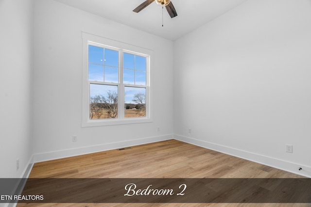 empty room featuring ceiling fan and light hardwood / wood-style flooring