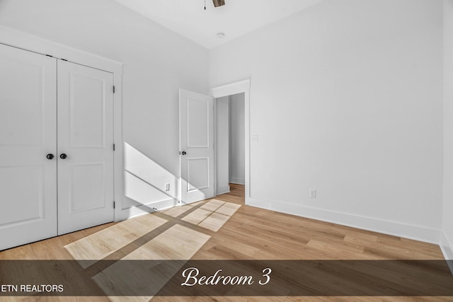 unfurnished bedroom with a closet and light hardwood / wood-style flooring