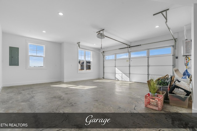 garage with a garage door opener and electric panel