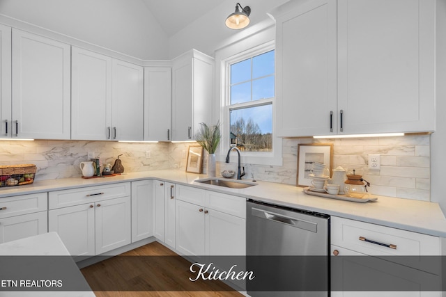 kitchen with white cabinets, stainless steel dishwasher, and sink