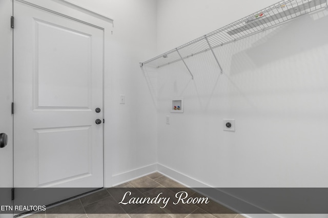 washroom with washer hookup, hookup for an electric dryer, and dark tile patterned flooring