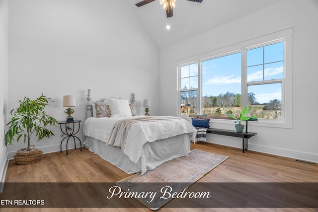 bedroom featuring hardwood / wood-style flooring, high vaulted ceiling, and ceiling fan