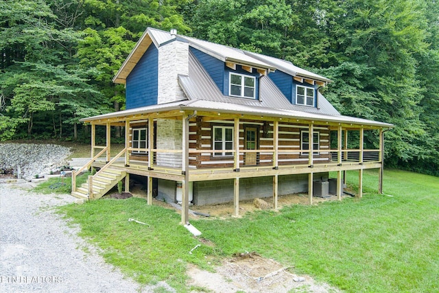 view of front of house with cooling unit, a front yard, and a porch