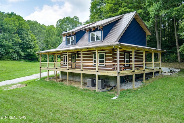 view of front of property featuring central AC and a front yard