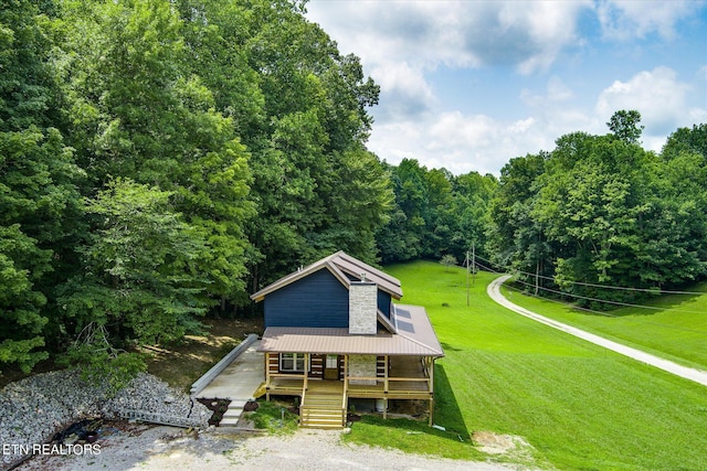 view of front of house with a front yard and a porch