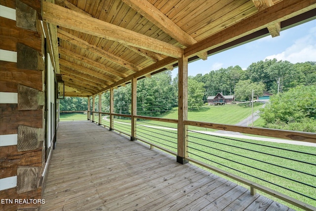 wooden deck featuring a yard