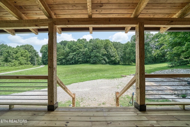 exterior space featuring beam ceiling, a wealth of natural light, hardwood / wood-style floors, and wood ceiling