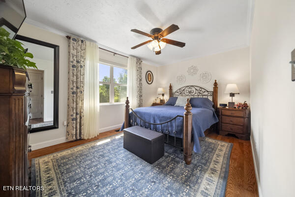 bedroom with ceiling fan and hardwood / wood-style flooring