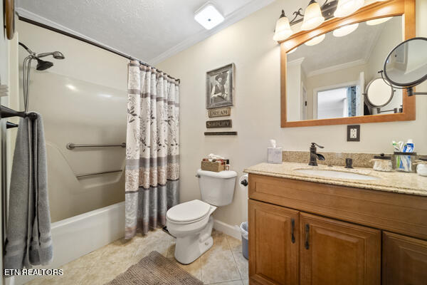 full bathroom featuring crown molding, toilet, tile patterned floors, vanity, and shower / bathtub combination with curtain