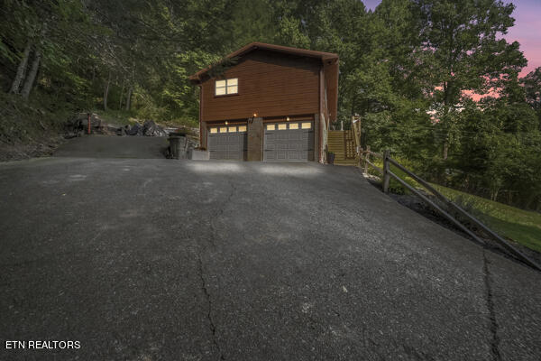 view of garage at dusk