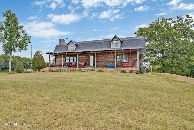 log home with a porch and a front lawn