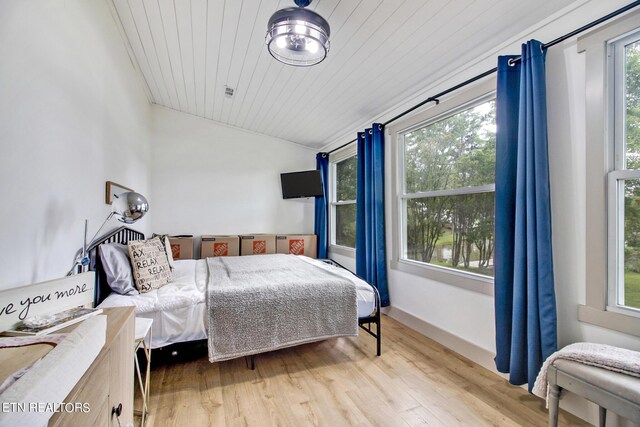 bedroom featuring wooden ceiling, baseboards, vaulted ceiling, and light wood finished floors