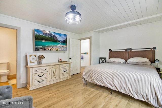 bedroom featuring wood ceiling, baseboards, light wood-style flooring, and ensuite bath