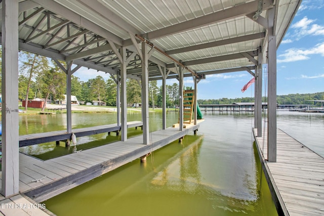 dock area with a water view and boat lift