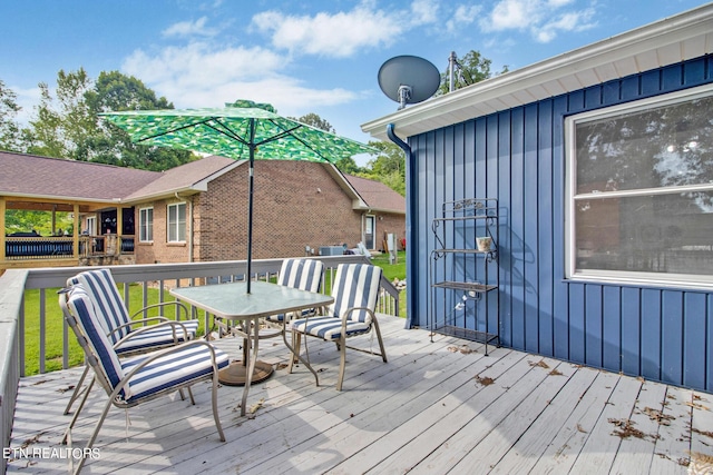 wooden terrace with outdoor dining area