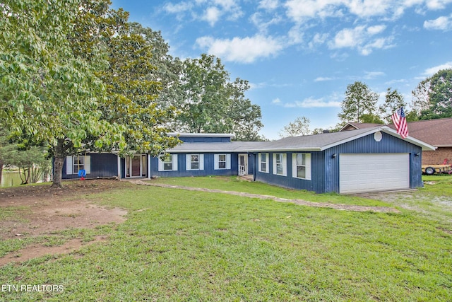 ranch-style home with a garage, driveway, and a front lawn