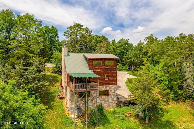 rear view of property with a balcony