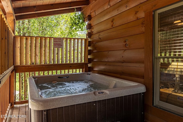 wooden deck featuring a hot tub