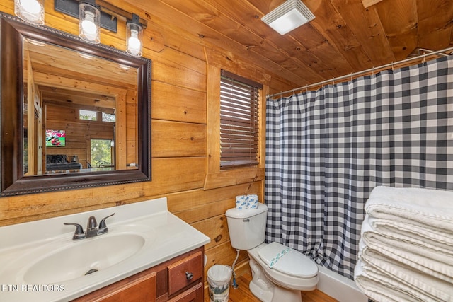 bathroom with wooden walls, toilet, vanity, wooden ceiling, and wood-type flooring