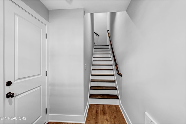 stairs with hardwood / wood-style floors